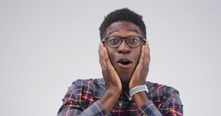 Shocked, portrait and black man in studio with wow expression, announcement or good news. Surprise, gossip and happy male person on white background for giveaway, discount glasses or emoji by spaceの写真素材