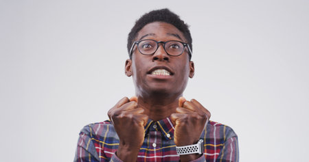 Scream, frustrated and black man in studio with stress, annoyed and mistake on white background. Mockup space, emotional and isolated person with anger shouting for burnout, mental health and crisisの写真素材