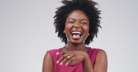 Laughing, funny and joke with black woman in studio for expression, comedy and goofy comic. Positive...