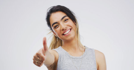 Thumbs up, woman and portrait in studio for agreement, yes emoji or like on white background....