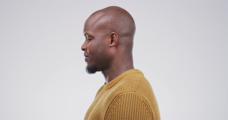 Black man, bald head and haircare in studio for healthy shine, alopecia and grooming results. Male person, beard and collagen treatment for hair loss, natural aging and haircut on white backgroundの写真素材