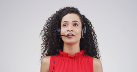 Call center agent, telemarketing and woman thinking in studio for lead generation or communication. Sales consultant, headset or contact us for outbound feedback or solution on white background spaceの写真素材