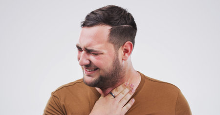 Sick, sore throat and man in studio with flu, cold or allergies by mockup space for respiratory...