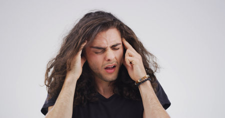 Pain, pressure or man with migraine in studio with stress, nervous breakdown or artist. Burnout space, hurt or creative designer with headache on white background with discomfort, dizziness or crisisの写真素材