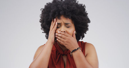 African woman, shocked and news in studio of bad reaction, mental health and unexpected announcement. Overwhelmed, female person and cover mouth with trauma, panic and revelation on white backgroundの写真素材