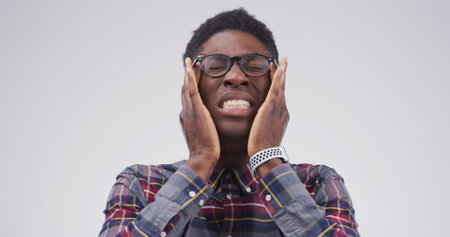 Headache, glasses and upset black man in studio with eye strain for migraine, brain fog and...