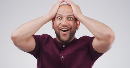 Portrait, shocked and mind blown with man in studio of announcement, good news and hearing secret. Surprise, person and space for gossip drama, giveaway winner and unexpected deal on white backgroundの写真素材