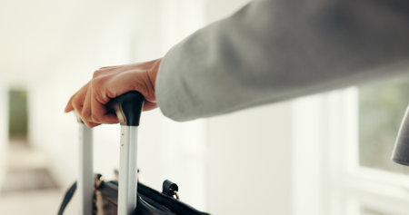 Hands, luggage and business person in hotel lobby for travel, immigration and international convention. Corporate employee, baggage and suitcase for tourism trip in corridor at accommodation lodgeの写真素材
