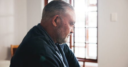 Sad, senior man and loneliness in nursing home, thinking and pensioner with Alzheimer and depressed....