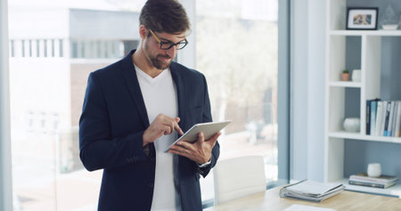 Businessman, tablet and research with report in office for planning, company consultant and performance analyst. Professional, client feedback and reading with person in agency for project ideaの写真素材