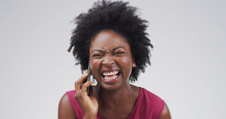 Funny, phone call and black woman in studio for laugh, communication and gossip story. Mobile, happy person and talking to contact for news, silly joke and chat on white background space for comedyの写真素材