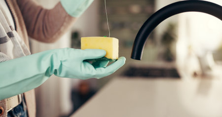 Cleaning, sponge and hands of person in kitchen for washing, hygiene and bacteria prevent. Sanitary, safety and dirt with cleaner and liquid in home for soap, housekeeping and germ disinfectantの写真素材