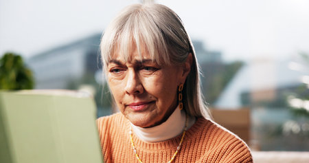 Elderly woman, confused and tablet in home with network error, connectivity and reading troubleshoot. Senior person, tech and thinking in retirement with notification, unknown software and doubt newsの写真素材