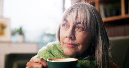 Old woman, coffee and smile with thinking on sofa for happy memory, daydreaming and weekend break....