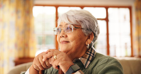 Walking stick, relax and senior woman in home with nostalgia, retirement or remember memory....