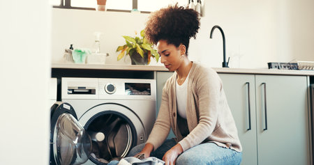 Clothes, basket and cleaning with woman and washing machine for laundry, hygiene and fabric softener. Housekeeping, cleaner and chores with person in home for washroom, fresh linen and detergentの写真素材