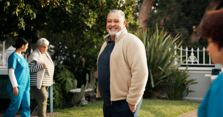 Happy, outdoor and portrait of mature man with smile for fresh air, wellness and relaxing in garden. Retirement, nursing home and senior person in nature for peace, health and assisted livingの写真素材