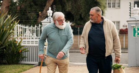 Home, groceries and senior man with help for assistance, support and care walking to door. Retirement, friends and elderly people with shopping bag of food outdoor for kindness, talking and chatの写真素材