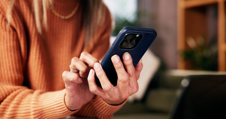 Hands, phone and scroll on sofa in living room with notification, contact or texting on web in...