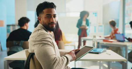 Tablet, learning and portrait of man in classroom for study or development in college. Tech, happy...