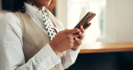 Hotel, receptionist and hands with smartphone, research or checking reservation on web and schedule. Motel, concierge and person with mobile for booking info, update and browsing for request on appの写真素材