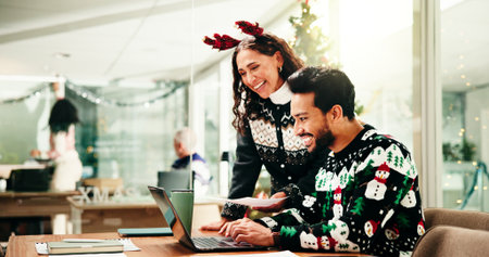 Laptop, Christmas and businessman with manager in office for review on finance proposal. Computer, xmas and male financial advisor with mentor for feedback on investment report in festive season.の写真素材