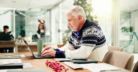 Christmas, business and man with laptop, thinking or problem solving with investment. Mature person,...