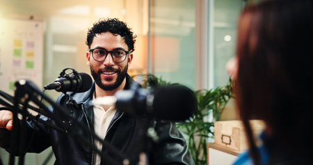 Podcast, conversation and man with woman in studio with guest for interview, discussion and talking....