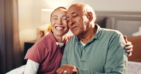Happy, hug and nurse with senior man in home for support, empathy or compassion on good news. Smile, relax and caregiver embracing elderly male person in bedroom for healthcare checkup in house.の写真素材