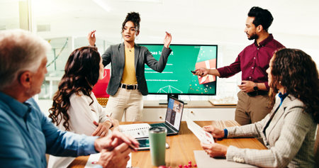 Serious, presentation and people in boardroom, talk and planning for holiday campaign and Christmas. Collaboration, man and woman with monitor for pitch, festive season or marketing strategy for xmasの写真素材