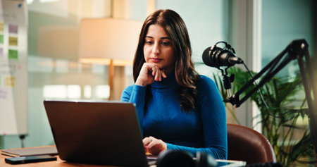 Reading, laptop and woman in studio for podcast, broadcast and talk show at media agency. Radio...