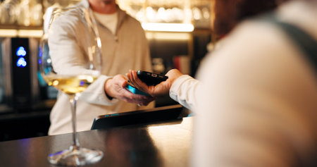 Bartender, hands and POS machine with phone for payment, wireless transaction or easy banking in...