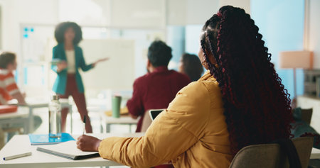 Back, professor and lecture with students in classroom for college, learning and lesson notes. University, education and teaching with people on campus for assignment research and curriculumの写真素材