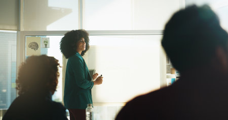 Happy woman, coaching or presentation with glass board for staff training, workshop or seminar. Female person, meeting or teaching with group of employees for information, ideas or learning on spaceの写真素材