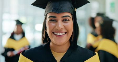 Excited, student and portrait of woman at graduation with education goal, degree or achievement. Happy, university graduate and female person with pride for college diploma on campus for success.の写真素材