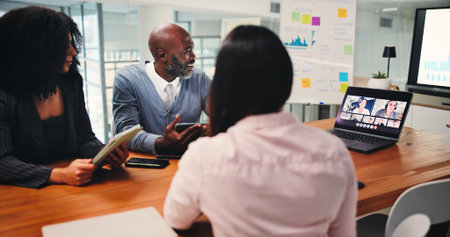 Boardroom, colleagues and group with laptop, video call or communication with client for investment. Business, meeting and people with tablet for virtual conference, discussion and pitch of proposalの写真素材