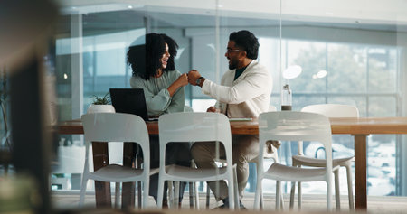Smile, people and fist bump with laptop in office for accounting, financial success and good news. Staff, collaboration and pc with team congratulations, proposal achievement and deal for investmentの写真素材