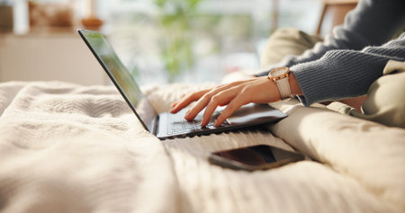 Laptop, hands and woman typing on bed for freelancer career with creative project online....