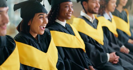 College, success and smile with woman at graduation for alumni ceremony, achievement and diploma pride. University, masters degree and academy milestone with people or students on campus for futureの写真素材