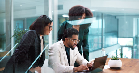 Collaboration, laptop and research with business people in boardroom together for discussion or update. Computer, conversation and planning with employee team in glass office for project managementの写真素材