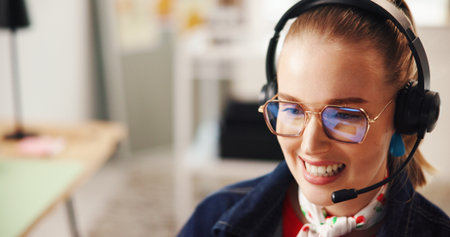 Happy woman, headset and consultant with mic for online communication or advice in home. Female person, agent or smile in remote work with glasses for telecommunications, help or virtual assistanceの写真素材