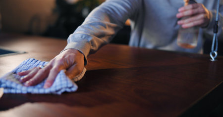 Cleaning, waiter and hands with spray, bar and chemical for hygiene, routine and sanitary for germs. Small business, disinfection and person with liquid for dirt, bacteria and maintenance at nightの写真素材