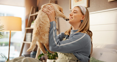 Playing, bonding and woman with dog on bed for happiness, connection or adoption in home. Love, relax and female person with Labrador puppy for pet, animal or companion in bedroom at house together.の写真素材