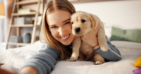 Happy, woman and selfie with puppy on bed for adoption memory, social media update or development. Dog mom, portrait and photography with labrador in home for profile picture, companion or connectionの写真素材