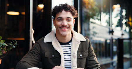 Portrait, happy freelancer and man at cafe as customer or creative copywriter with confidence. Smile, remote work and person at coffee shop with content writer, professional and startup in Portugalの写真素材