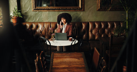 Phone call, laptop and remote work with woman in cafe for communication, entrepreneur and research. Planning, startup contact and freelancer with person in coffee shop for client email and chatの写真素材