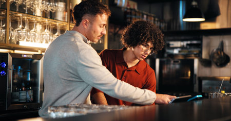 Bar, waiter and manager with tech for order, teamwork and training of employee to review sales data....