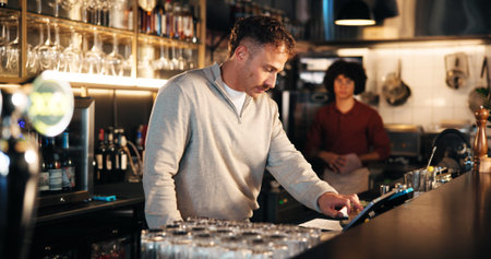 Bartender, manager and tablet at pub for POS, inventory checklist and inspection for small business...