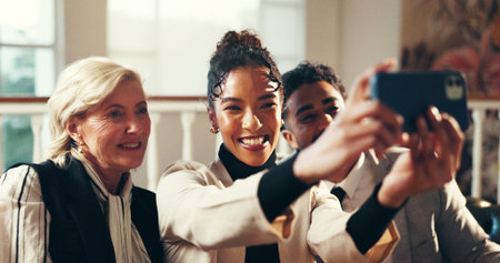 Business people, team and meeting with selfie for picture, memory or photography in hotel. Excited, group or employees with smile for capture moment, travel or waiting together in luxury lodgeの写真素材