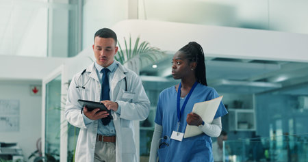 Tablet, doctor and nurse in hospital for healthcare discussion, planning schedule or telehealth....